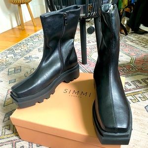 These are black lug sole boots by Simmi London. They are vegan leather material.